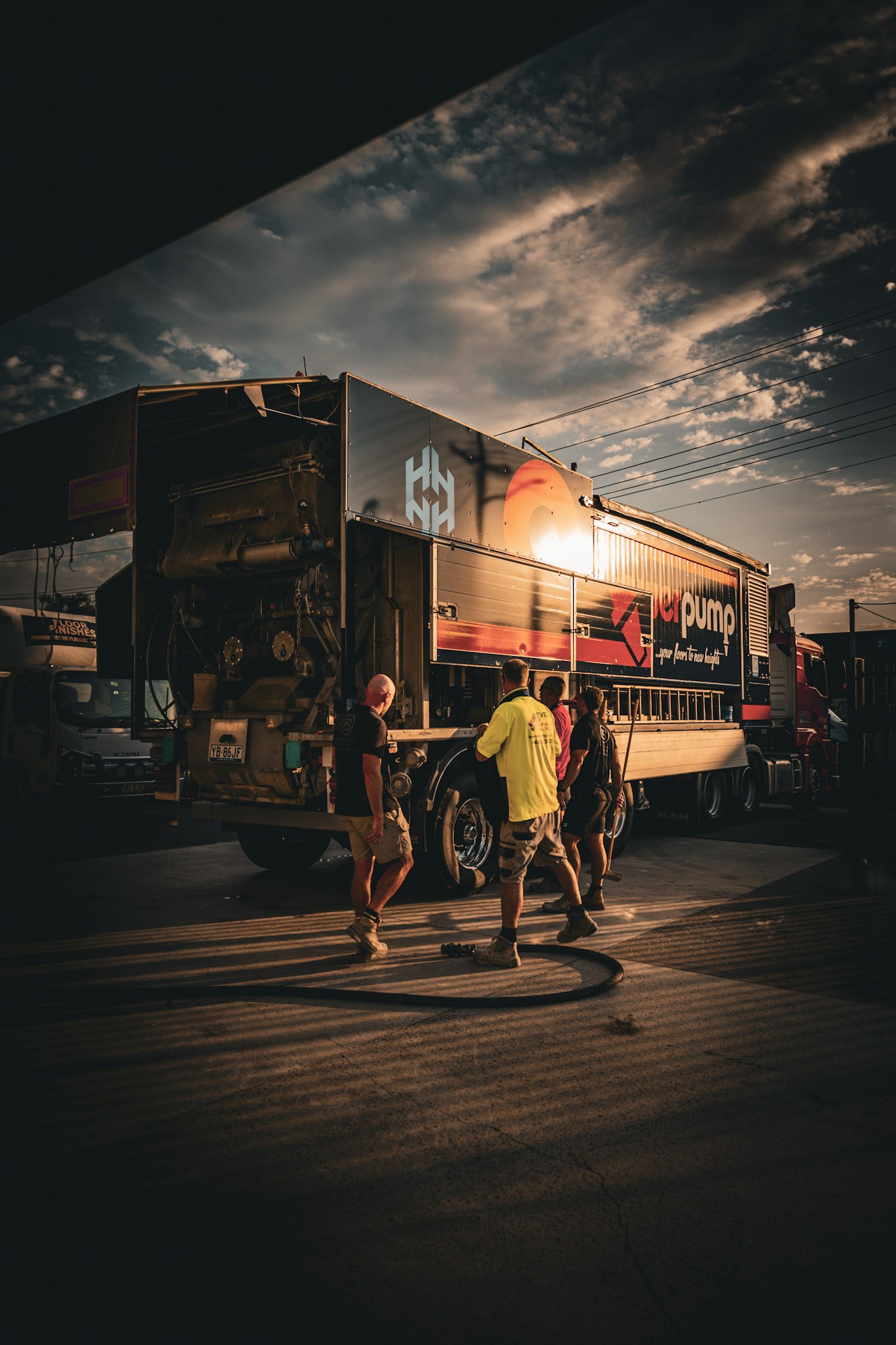 PowerPump crew and screed pump truck on a Sydney job site at sunrise